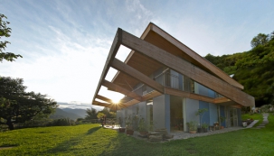Architektonický výraz domu jednoduchého tvaru určuje  velký slunolam z lepených dřevěných hranolů, který jej zvenku obepíná ze tří světových stran. S touto konstrukcí koresponduje přesahující střecha, obložená rovněž neupraveným modřínovým dřevem.