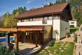 Pokoj pro hosty je obložen dřevem, na jižní straně na něj navazuje pergola