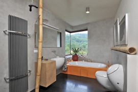 Koupelna nabízí krásný výhled do zeleně. I zde architekt použil neobvyklé rohové okno. Sanitární keramika má zajímavě oblé tvary (design Alessi)