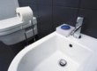  Každý detail v koupelně se podřizuje minimalistickému pojetí. Listely s motivem dětské kresby lidských postaviček oživují strohost obkladu 